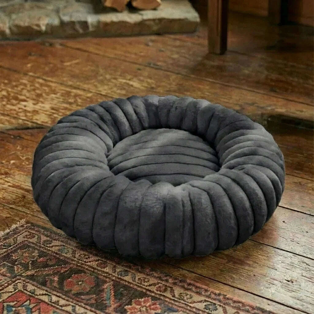 Black round cat bed, close-up