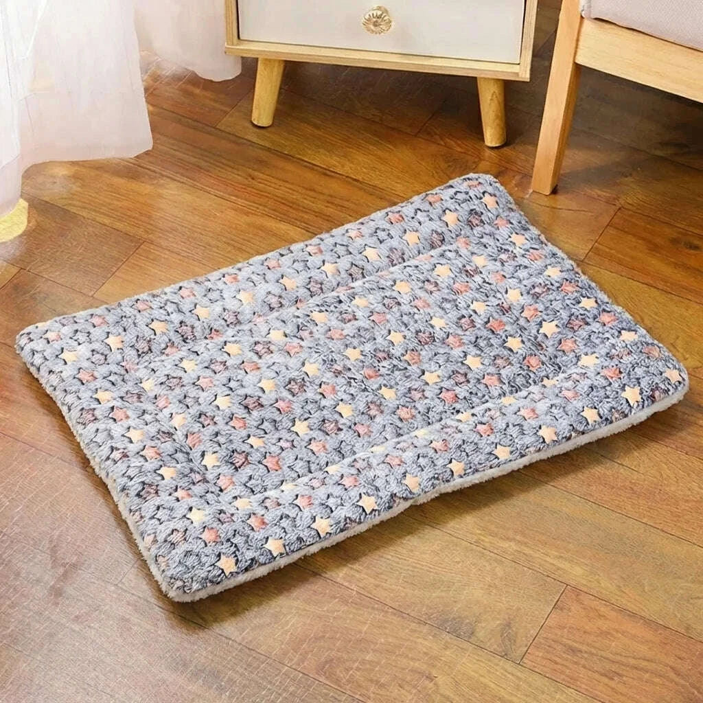 Couchage douillet pour chat gris à étoiles, vu en entier sur un parquet près d'une table de chevet