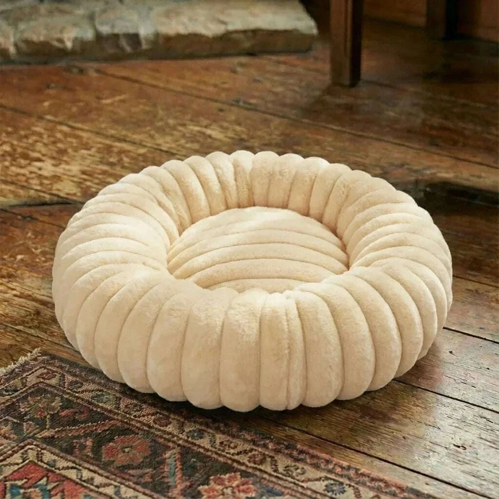 Beige round plush cat bed