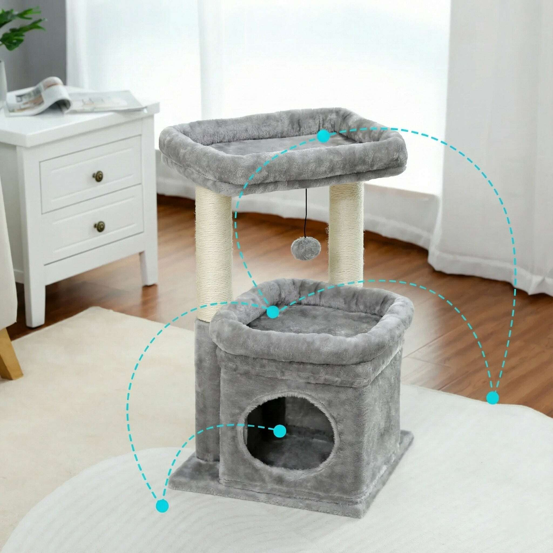 Arbre à chat gris posé près d'une table de chevet blanche, avec pointillés turquoise sur les zones de repos